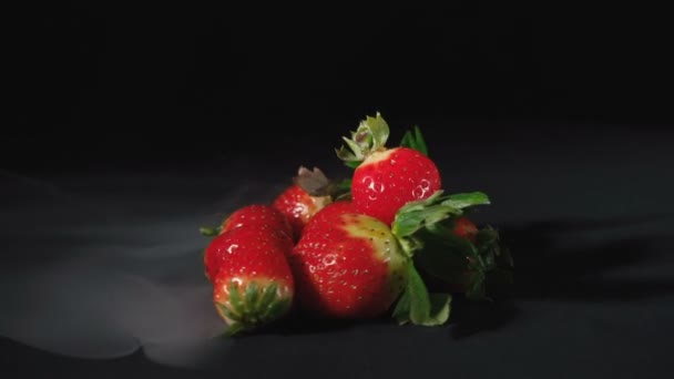 Shooting of rotating sweet strawberry on black background — Stock Video