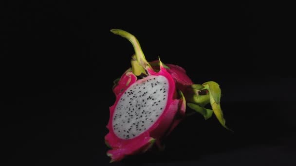 Video of rotating exotic dragon fruit on black background — Stock Video