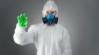 Koruyucu kıyafetli doktorun virüs testi görüntüsü.