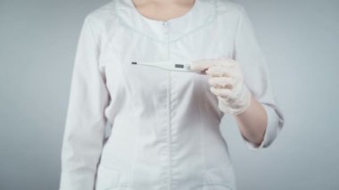 Doktorun elinde tıbbi termometre tutarken görüntüsü