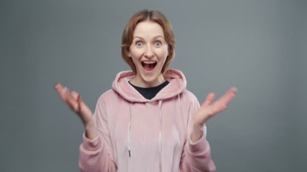 Video of young happy woman in pink sweatshirt — Stock Video