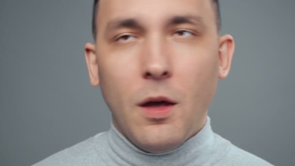 Video of young grimacing man in turtleneck — Stock Video