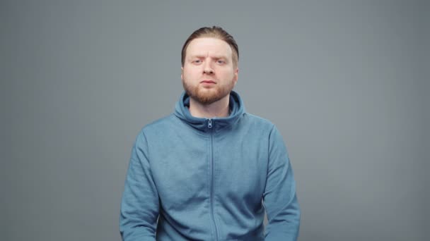 Video van serieuze blonde man in blauw sweatshirt — Stockvideo