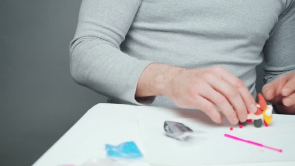 Father and little boy making toys from plasticine — Stock Video