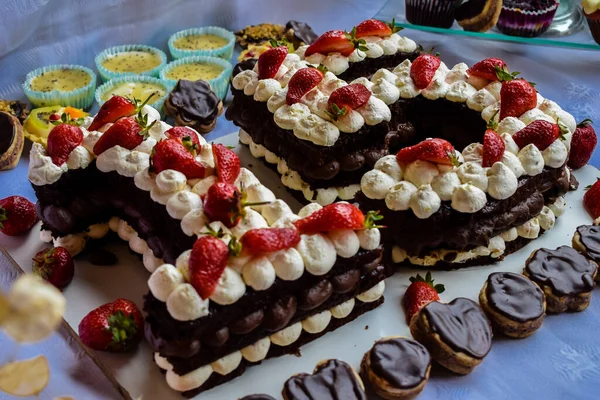 Mini candy bar with cupcakes and birthday cake with cream cheese