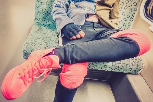 Urban fashion man sitting in subway train - Close up detail of male generic alternative clothes - Vintage lomo vignetted filter with shallow depth of field and focus on hand and jeans velvet jacket — Stock Photo, Image