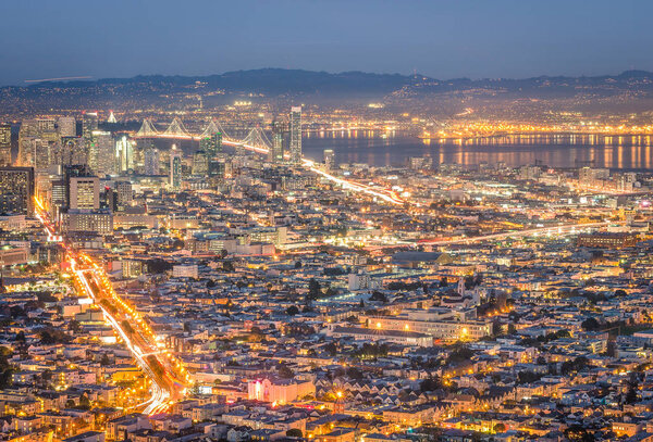 Skyline of San Francisco Bay at night from panorama view point lookout of Twin Peaks - Urban travel concept with american world famous city on the atlantic coast - warm night color tones