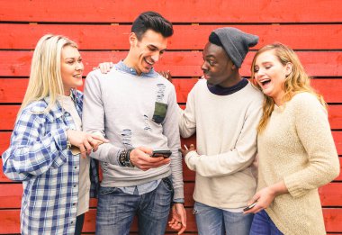 Multiracial hipster best friends group having fun together with smartphone - Modern technology interaction concept with young people using mobile smart phone - Wifi internet connection spots outdoors clipart