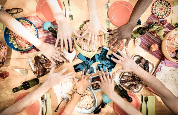 Top view of friend hands with mobile smart phones at barbecue garden party - Multiracial people group enjoying grill meal at backyard bbq -  Food and tech concept outdoors - Warm desaturated filte — Stock Photo, Image