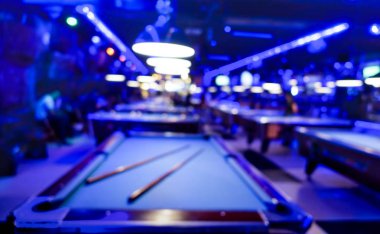 Defocused background of billiard playroom - Blurred composition of pool game saloon with dominant blue color tones and incandescent neon light - Fun and entertainment concept with blurry dark backdrop clipart