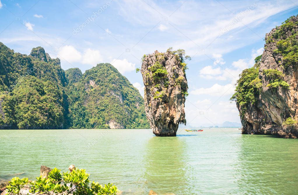 James Bond Island in Phang Nga Bay - World famous destination near Phuket in Thailand - Wanderlust travel concept with paradise landscape on turquoise water and thick vegetation - Bright vivid filter