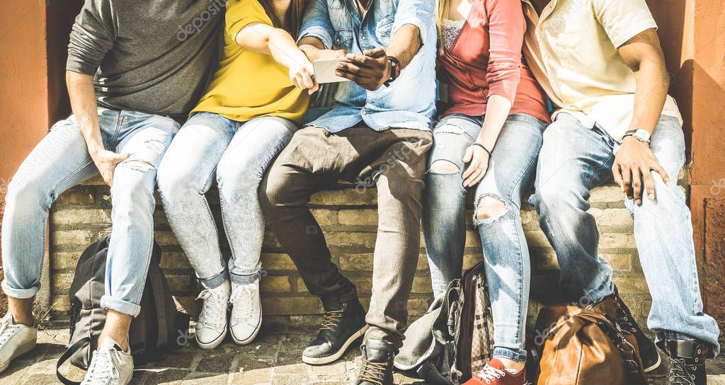 Group of multiculture friends using smartphone on urban background - Technology addiction concept in youth lifestyle disinterested to each other - Always connected people on modern mobile smart phones