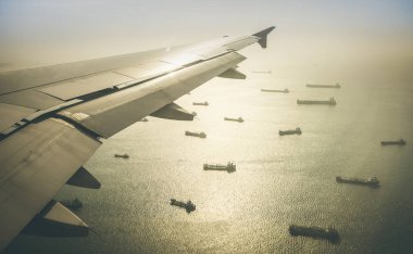 Aerial view of industrial cargo ships fleet moving to the harbour of Singapore in south east Asia - Retro contrasted dramatic filter clipart