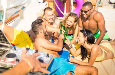 Group of multiracial friends having fun drinking at sail boat party with dj set - Friendship concept with young multi racial people toasting beer on sailboat - Travel lifestyle on warm vivid filter clipart