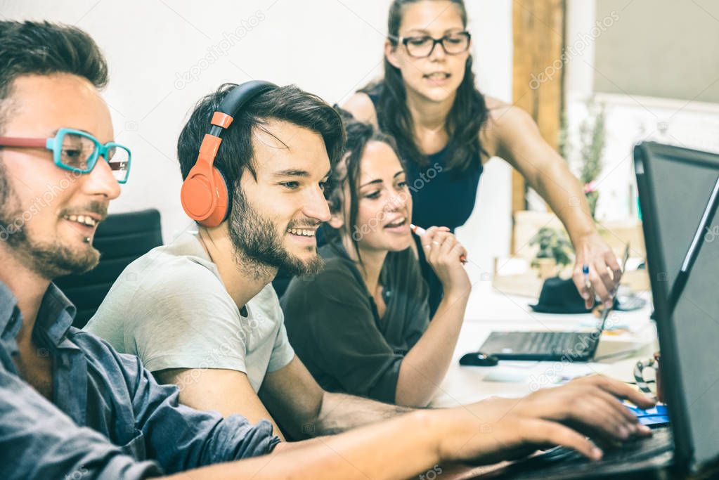 Group of young people employee workers with computer in startup studio - Human resource business and teamwork concept on laptop working time - Start up entrepreneurs at office - Teal and orange filter