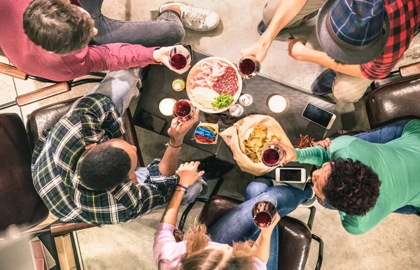 Top view of multi racial friends tasting red wine and having fun at fashion bar winery restaurant - Multicultural friendship concept with people enjoying time drinking together - Indoor neutral filtern — Stock Photo, Image