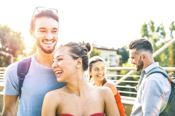 Happy friends group enjoying bike tour around city park - Friendship concept with young real people on spring summer cloth having fun together - Bright warm color tones with vintage sunshine filter — Stock Photo, Image