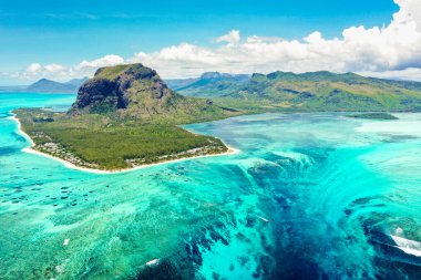 Aerial panoramic view of Mauritius island - Detail of Le Morne Brabant mountain with underwater waterfall perspective optic illusion - Wanderlust and travel concept with nature wonders on vivid filter clipart