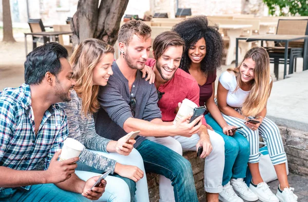 Young student friends group using smartphone with coffee at university college - People addicted by mobile smart phones - Technology concept with always connected trendy millennials - Neutral filter — 스톡 사진