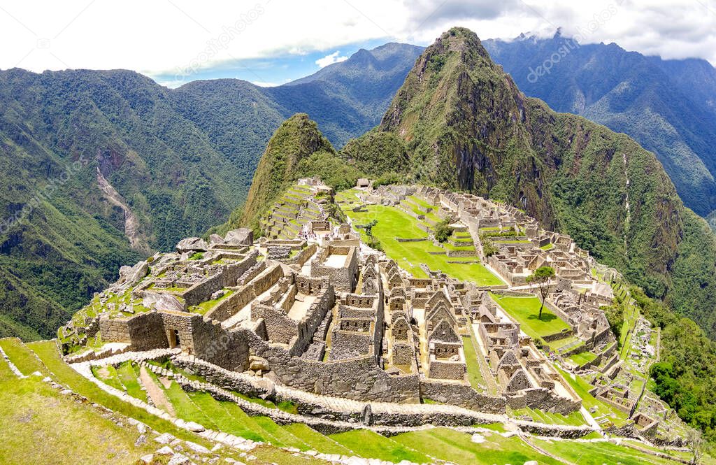 Panoramic view of Machu Picchu lost city at archaeological ruins site in Peru - Exclusive travel destination and natural wonder in world famous Inca trail on peruvian mountains