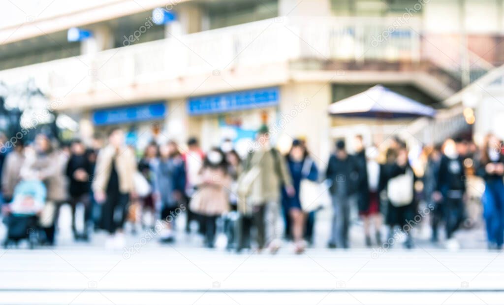 Blurred defocused abstract background of people walking on street - Crowded city center at rush hour in urban area over zebra crossing - Social concept with commuters on the move - Bright azure filter