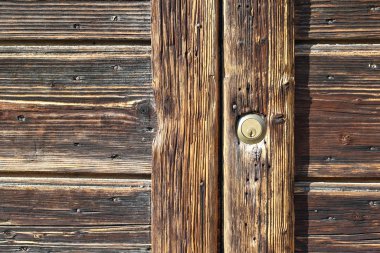 Closeup of old lock and keyhole on a old wooden door as a beautiful vintage background. Part of old wooden gate.