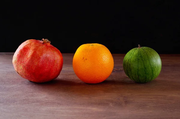 Fruits: pomegranate, orange and watermelon. — Stock Photo, Image