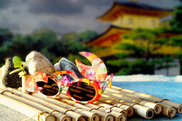 Childrens glasses on a bamboo Mat. Summer motif.