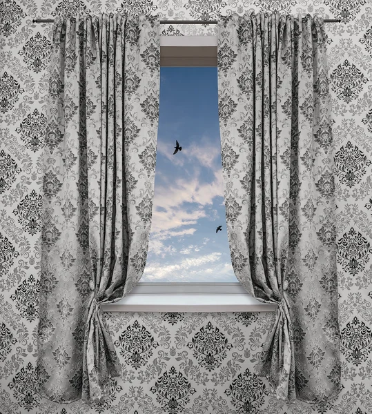 The window overlooking the blue sky, light clouds, and flying birds. The combination of color and ornament in the interior on the wallpaper and on the curtains.