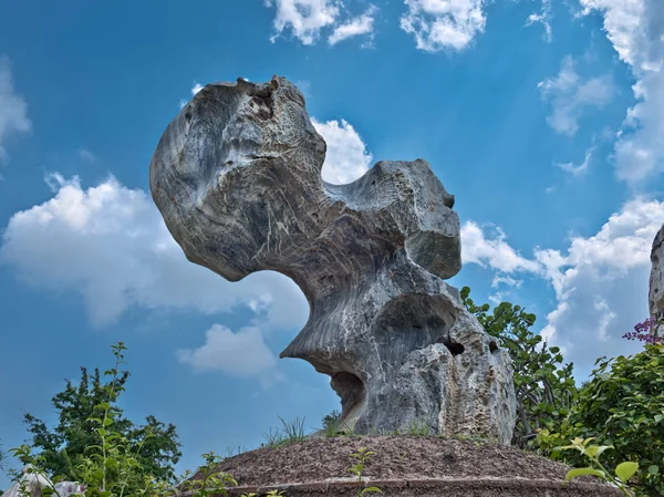 Thailand. Pattaya. Garden of millions of stones. A quaint stone sculpture in against the blue sky and white clouds. — Stock Photo, Image