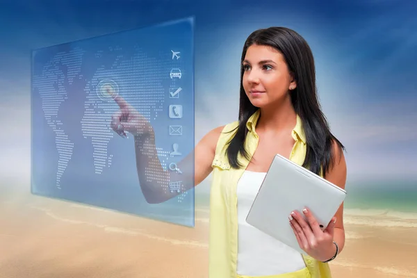 A young brunette girl in a yellow summer shirt pulls a button on a virtual screen, makes purchases and plans a vacation in the future
