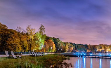 Moscow. October 6, 2019. Meshchersky pond at night. Beautiful autumn landscape with beach and wooden bridge view.