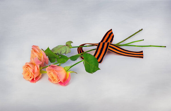 A bouquet of three roses and a St. George ribbon, in honor of the day of victory