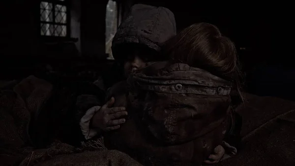 sad dirty homeless siblings hugging in abandoned building