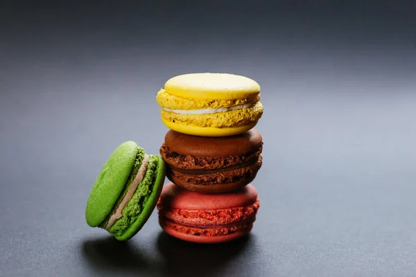 Colorful macaroons. French dessert multicolored cake on a gray background. Fragrant dessert.