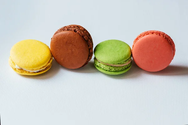 Colorful macaroons. French dessert multicolored cake on a white background. Fragrant dessert.