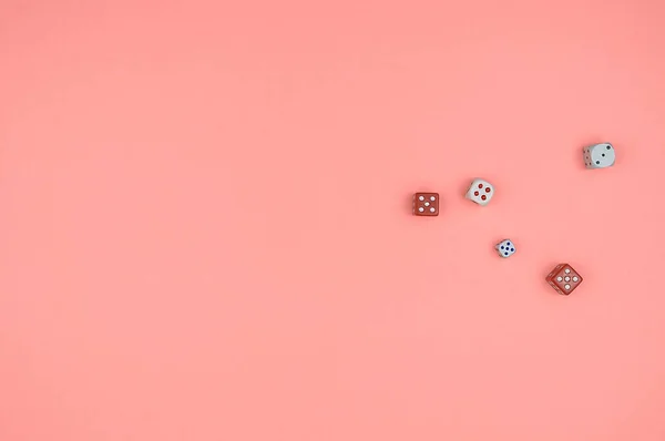 Dices, dice on a pink background.