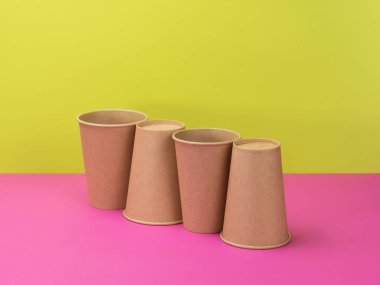 Pembe ve açık yeşil arka planda tek kullanımlık sofra takımı. Çevre koruma ve kullanım konsepti.