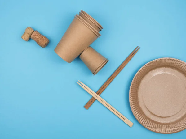 Kitchen items from natural organic materials against a blue background. The view from the top. Environmental set.