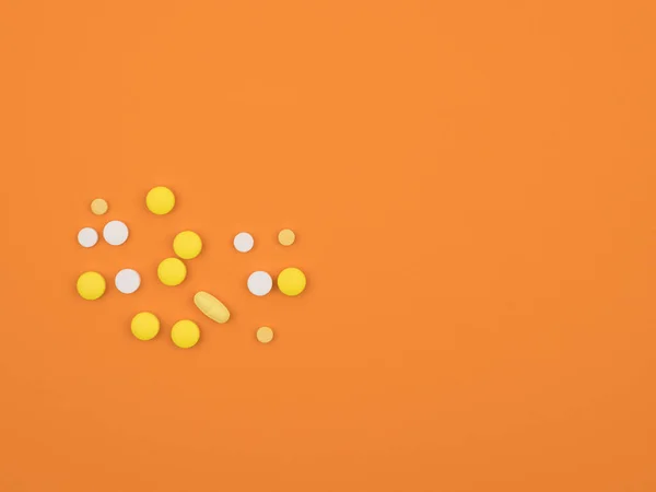 Verschiedene Pillen auf orangefarbenem Hintergrund in Nahaufnahme. Der Blick von oben. — Stockfoto