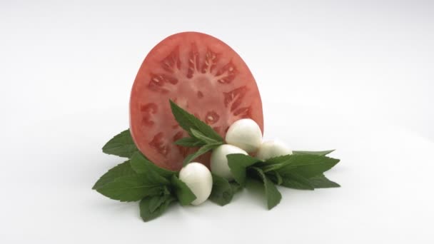 Soft cheese, tomato and mint on a white background. — Stock Video