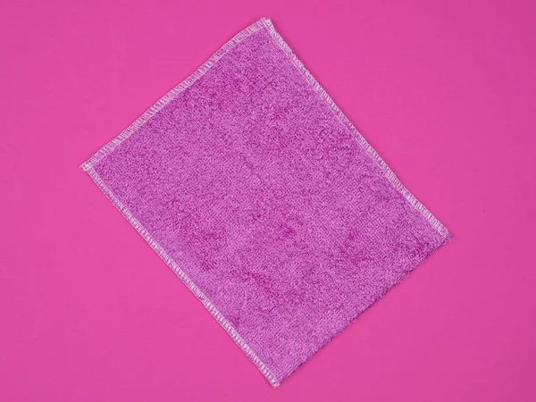 Pink napkin for cleaning on a pink background. Stock Image