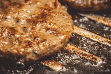 burger being fried in a frying pan