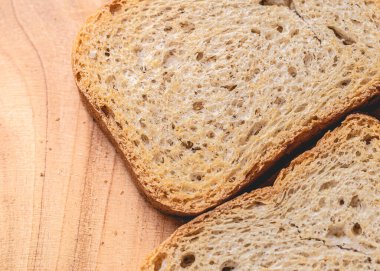 wholemeal toast ( torrada integral ) in close-up on a wooden board.