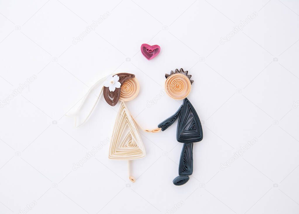 The romantic bridal couple. Hand made of paper quilling technique. Love, wedding concept. Groom and bride.