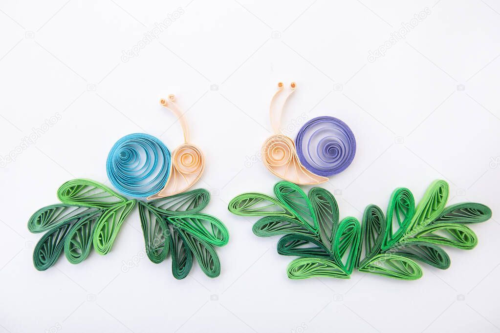 Snails on a leaves. Hand made of paper quilling technique.