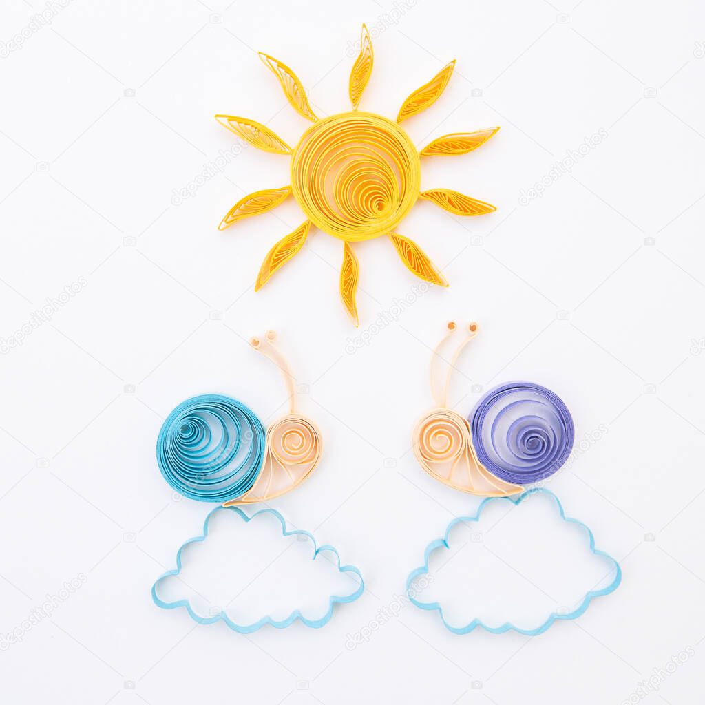 Snails on the clouds under the sun. Hand made of paper quilling technique