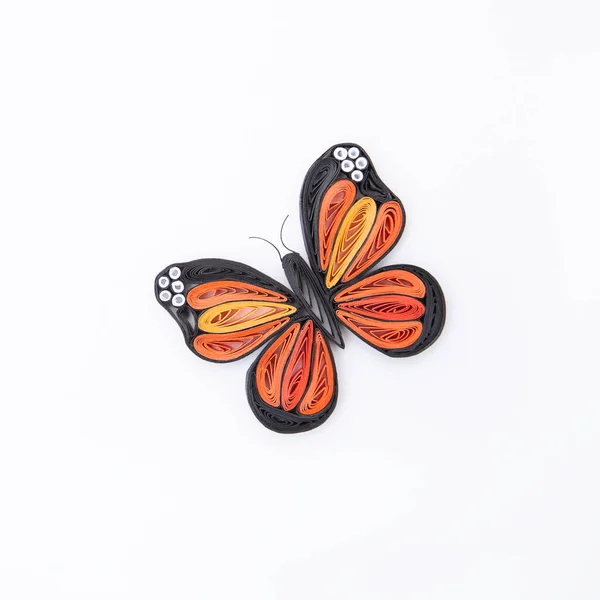 Top view of beautiful butterfly, isolated on white background. Hand made of paper quilling technique.