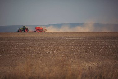 Traktördeki çiftçi gelecek yıl için tohum yatağıyla toprağı hazırlıyor..