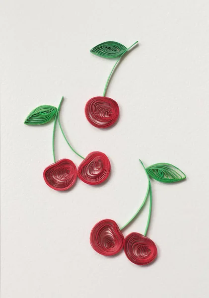 Beautiful Ripe cherries designs isolated on white background. Paper quilling of cherry - fresh fruit, natural berry. Berries with stems and green leaves. Hand made of paper quilling technique.